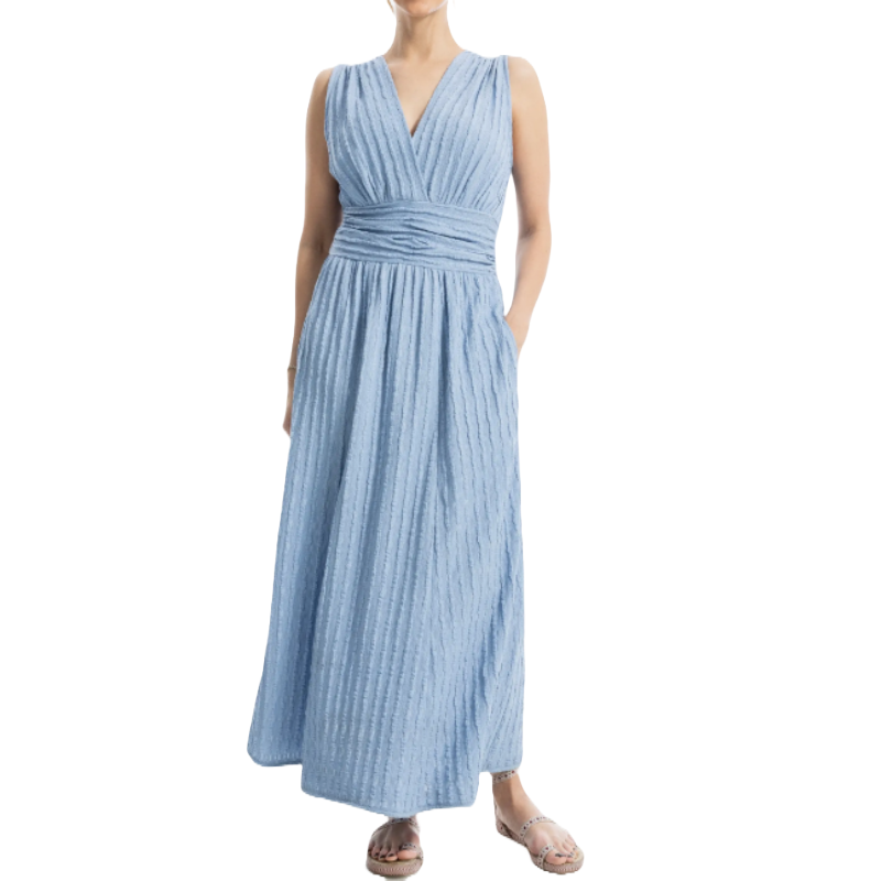 Light blue sleeveless maxi dress with a textured knit design, featuring a deep V-neck and a ruched waistband. Paired with flat sandals.