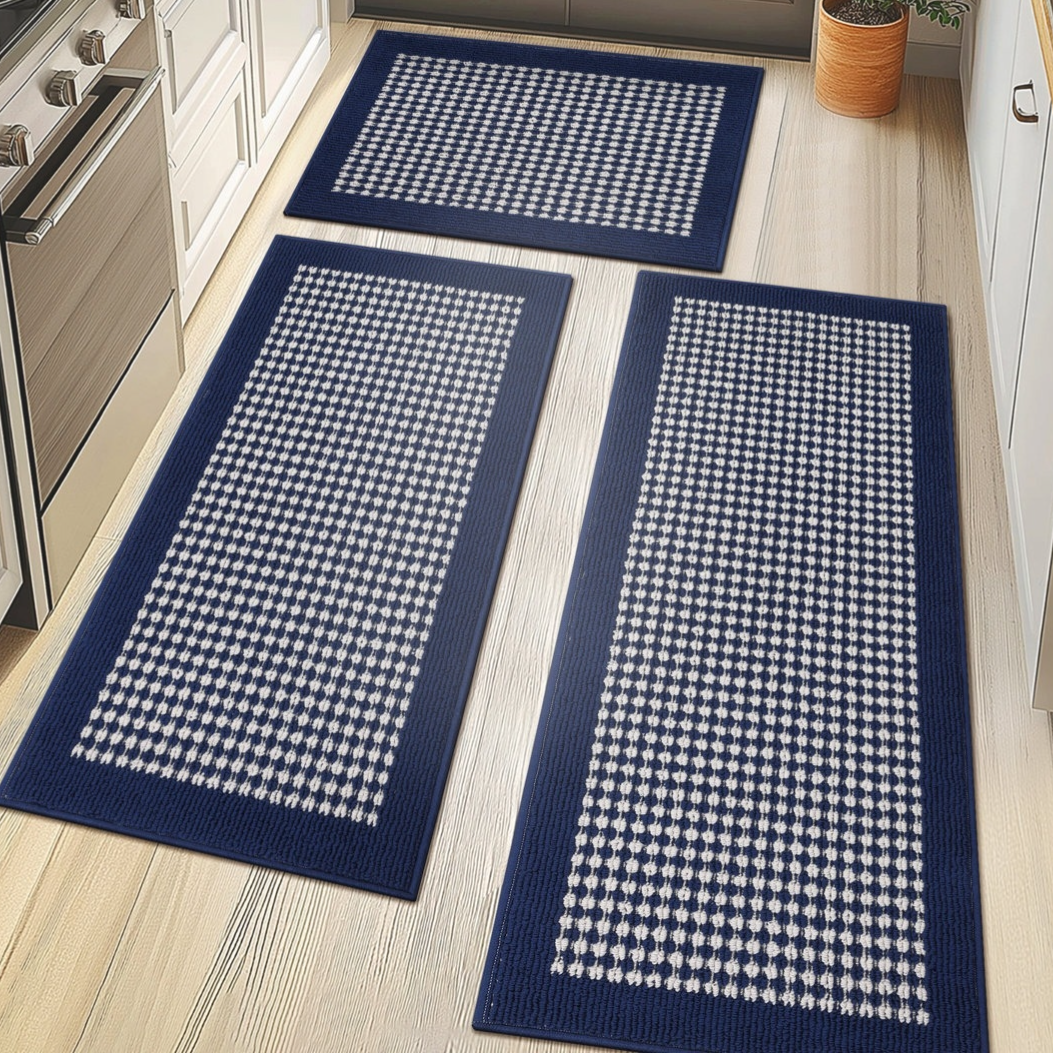 Three rectangular blue and white checkered rugs are displayed on a light wood floor in a kitchen setting.