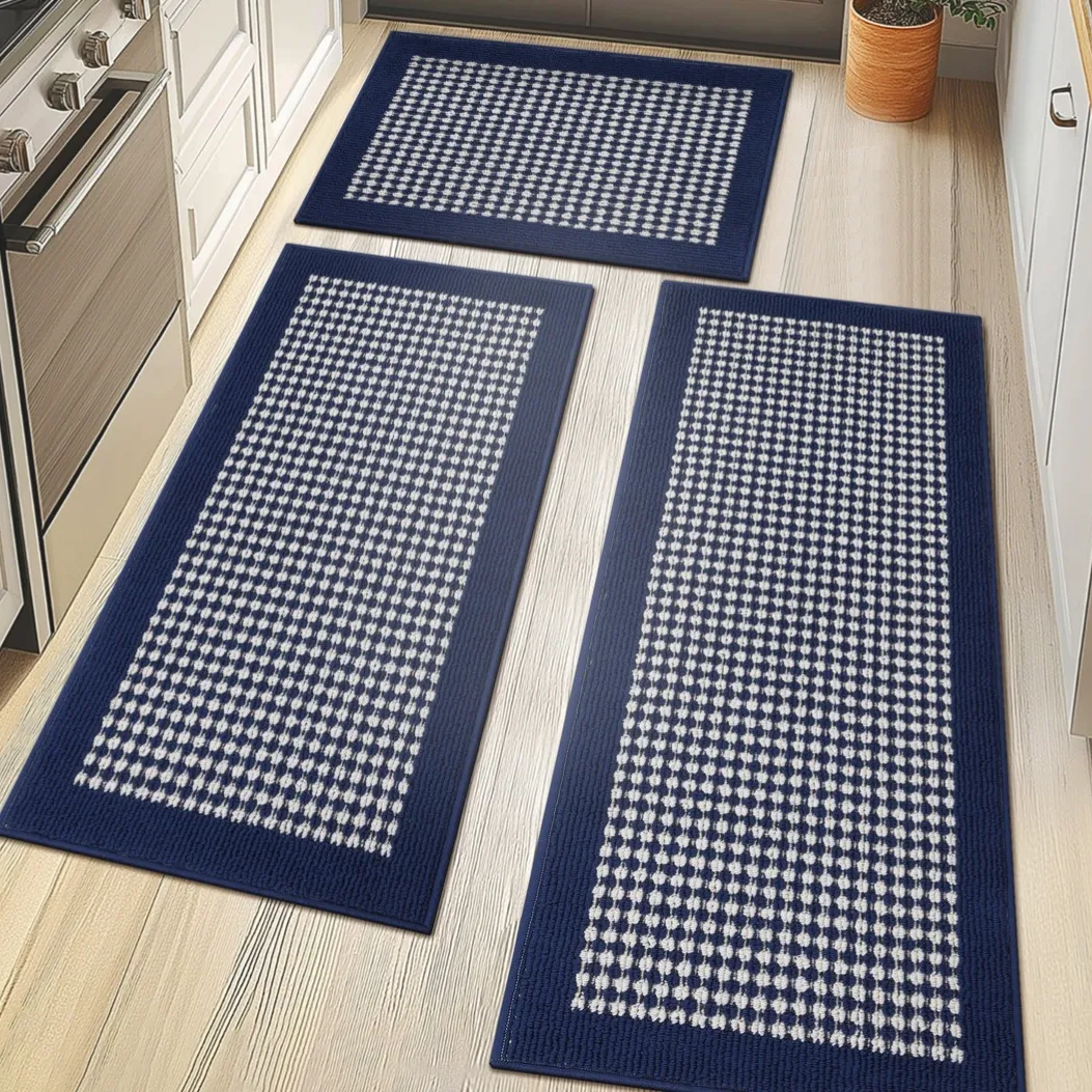 Three rectangular blue and white checkered rugs are displayed on a light wood floor in a kitchen setting.