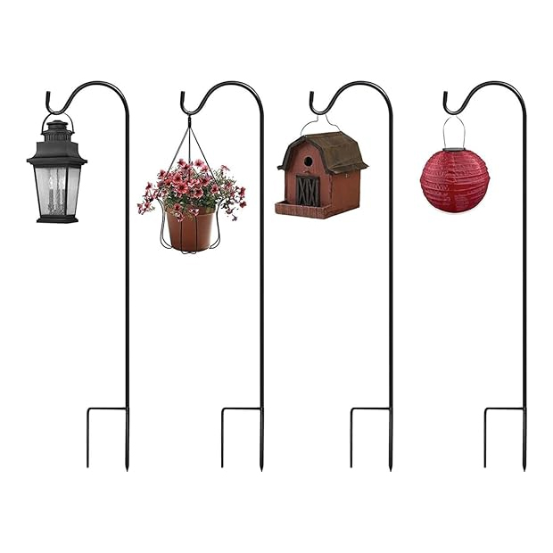 A set of four black metal garden shepherd's hooks, each with a different item hanging: a lantern, a potted plant, a birdhouse, and a red lantern. Designed for outdoor decorating or utility.