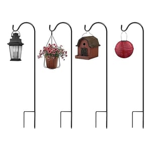 A set of four black metal garden shepherd's hooks, each with a different item hanging: a lantern, a potted plant, a birdhouse, and a red lantern. Designed for outdoor decorating or utility.