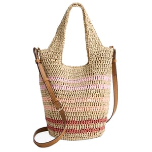 A woven straw tote featuring a soft, packable design with a striped pattern in pink and red hues, complemented by a brown leather shoulder strap and handles.