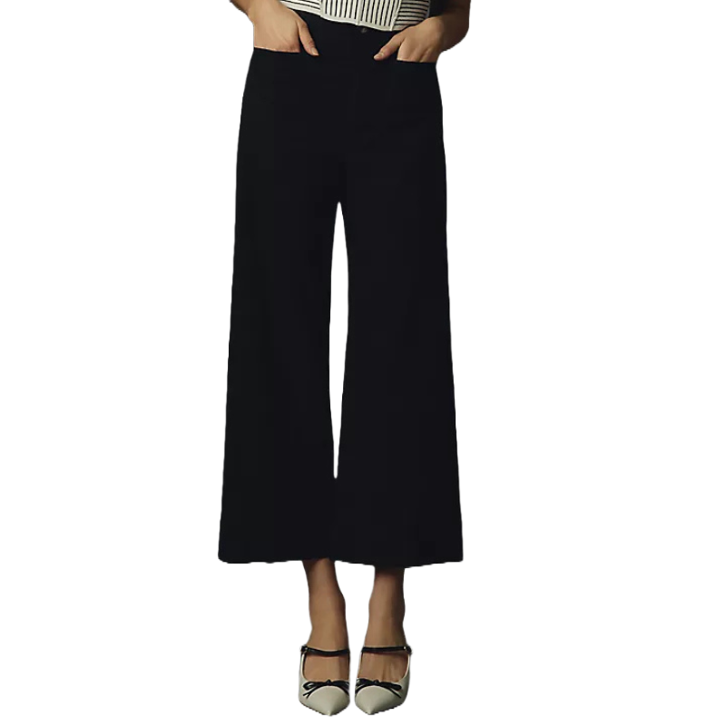 Black cropped wide-leg pants with a high waist, paired with black and white pointed-toe shoes featuring ankle straps and a bow detail.