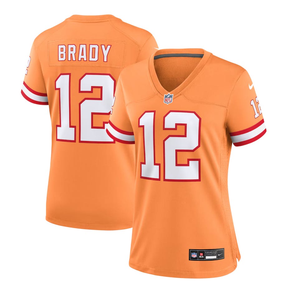 Orange NFL jersey with \“Brady\“ and number 12, featuring red and white stripes on the sleeves, Nike branding, and an NFL logo on the chest.