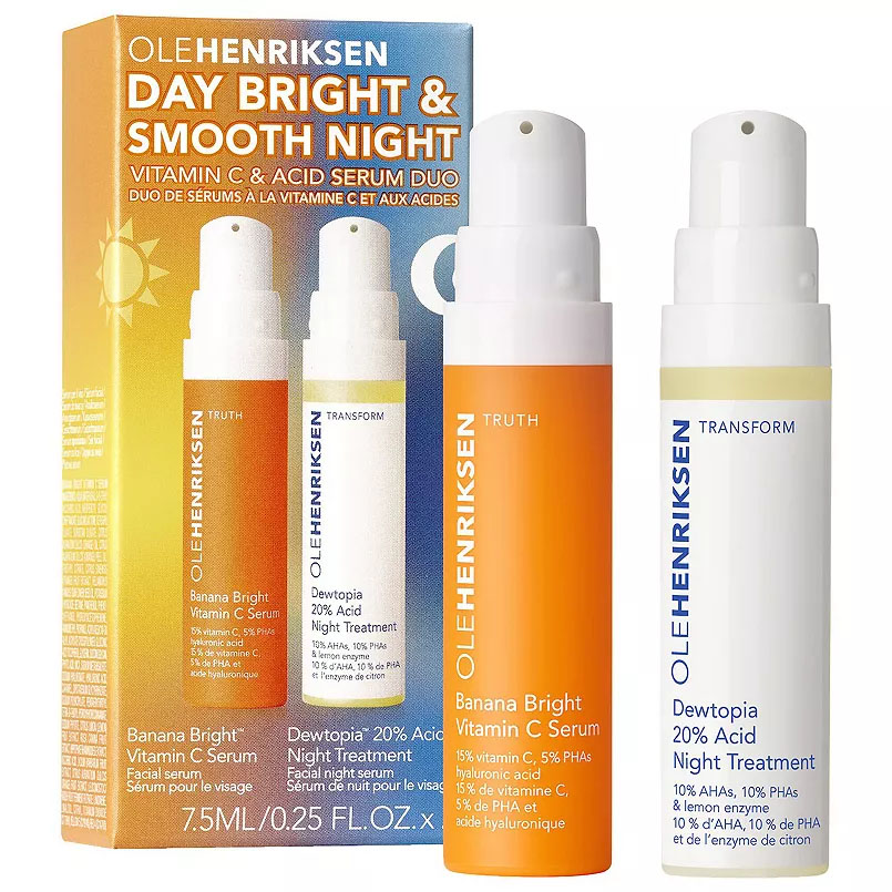 Two Ole Henriksen serum bottles, one labeled \“Banana Bright Vitamin C Serum\“ for day use and the other \“Dewtopia 20% Acid Night Treatment,\“ both in a yellow and white packaging.