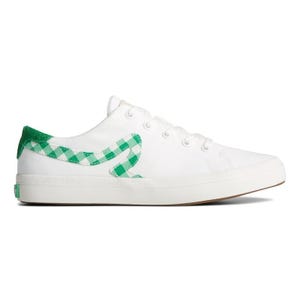 White low-top sneaker with green checkered details and a wave pattern on the side.