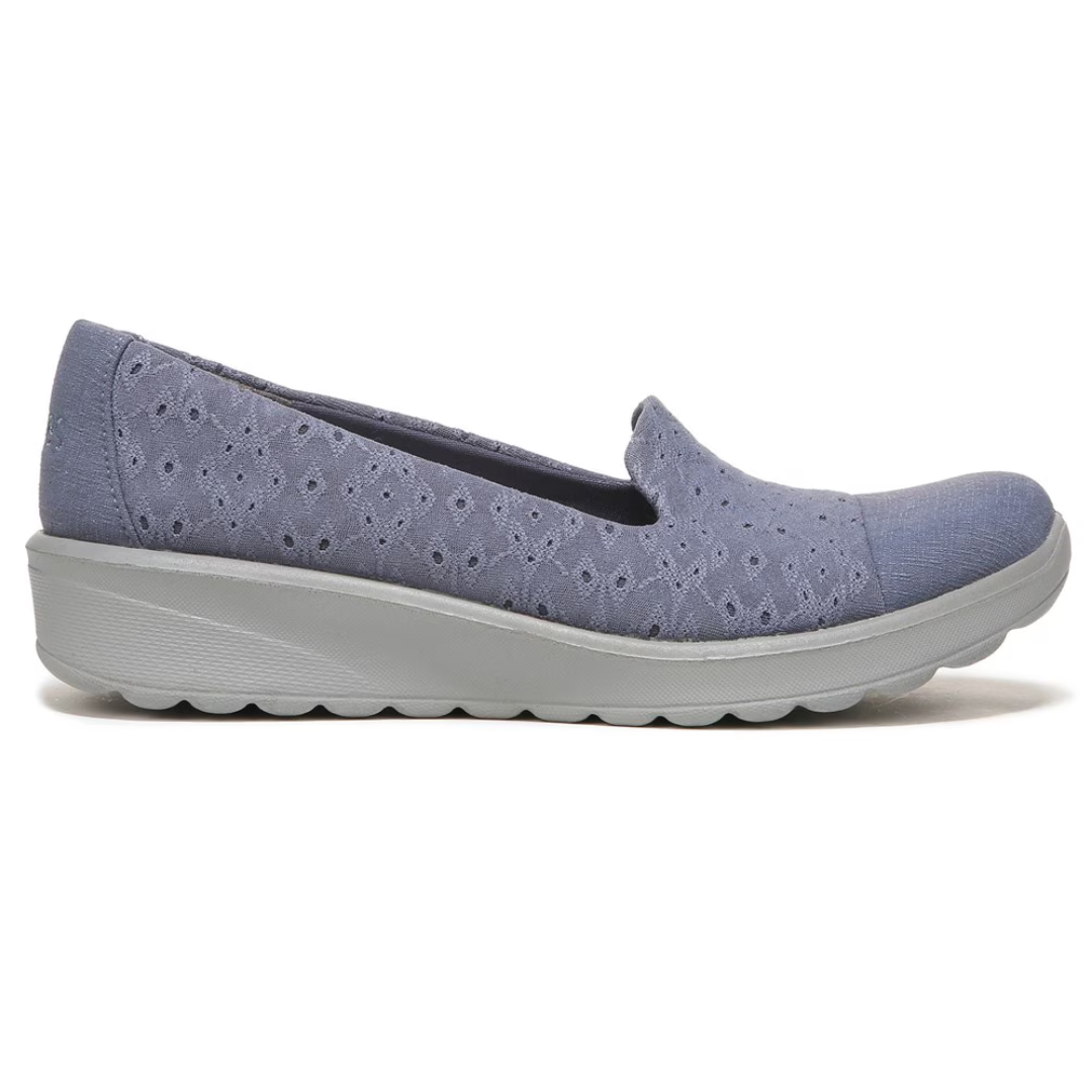 A single blue women's slip-on shoe with a floral pattern and a white sole.