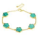 Gold bracelet with adjustable chain, featuring five flower-shaped charms with turquoise and blue striped inlays.
