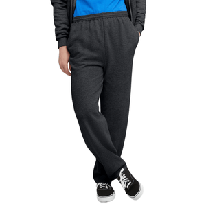 A person is wearing dark gray sweatpants paired with black sneakers and a blue shirt. The sweatpants have an elastic waistband and a relaxed fit.