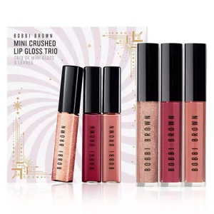 Bobbi Brown Mini Crushed Lip Gloss Trio includes three shimmering gloss shades. The packaging features a festive design with gold accents.