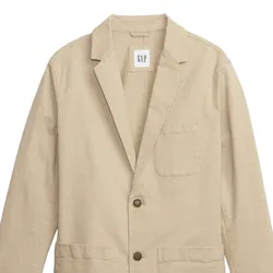 Beige blazer with two buttons, a left chest pocket, and two front pockets. Features a label with \“GAP\“ tag inside the collar.