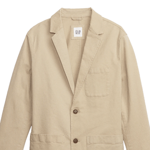 Beige blazer with two buttons, a left chest pocket, and two front pockets. Features a label with \“GAP\“ tag inside the collar.