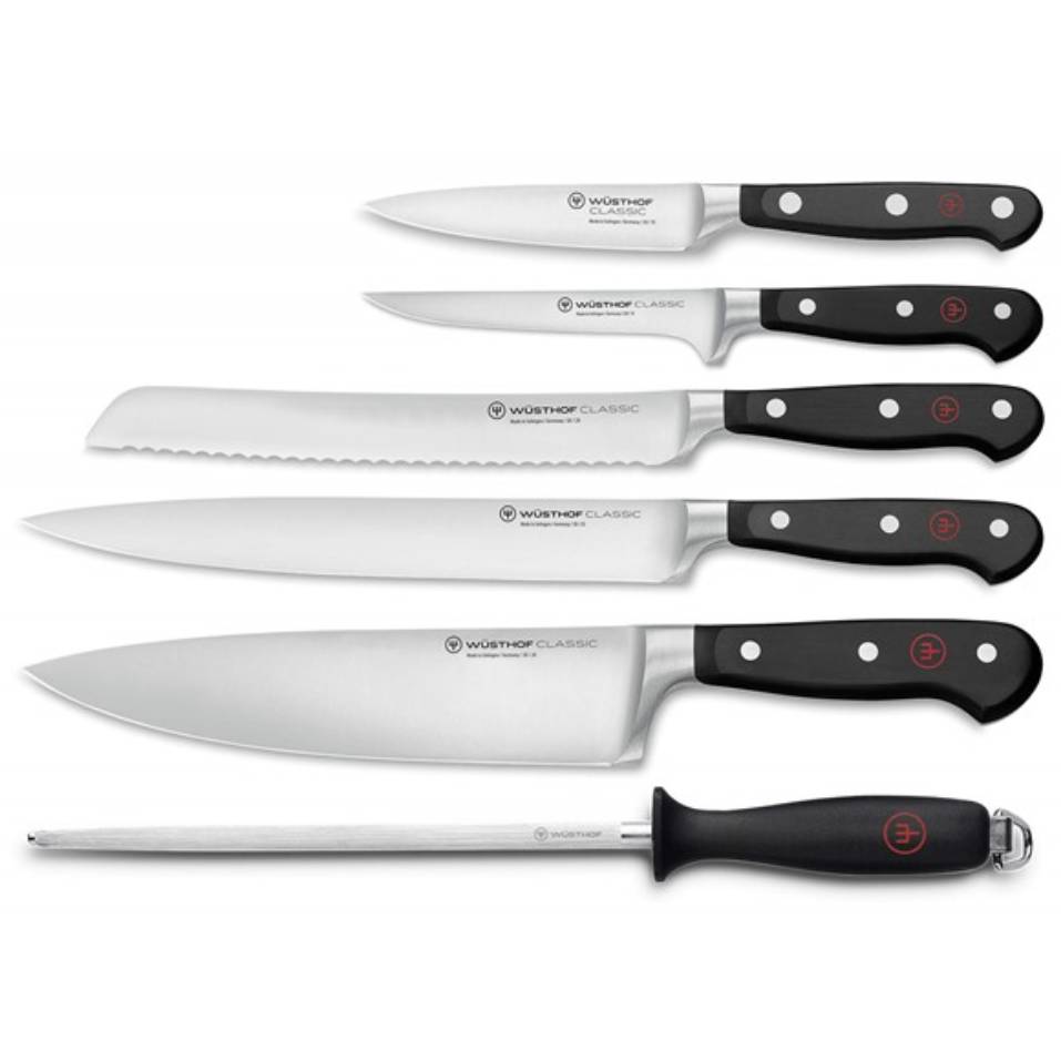 Wüsthof Classic knife set includes a paring knife, utility knife, bread knife, Santoku knife, chef's knife, and honing steel, each with a black handle and rivets, known for their durability and precision.