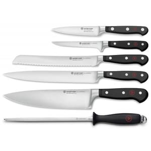 Wüsthof Classic knife set includes a paring knife, utility knife, bread knife, Santoku knife, chef's knife, and honing steel, each with a black handle and rivets, known for their durability and precision.