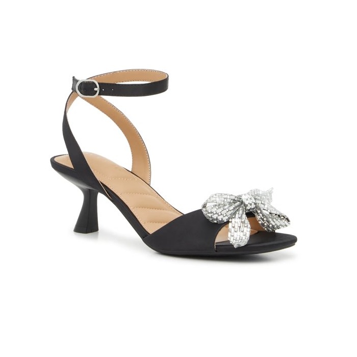 Black heeled sandal with an adjustable ankle strap and a pointed heel, featuring a silver sequined bow on the toe strap.