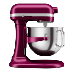 A magenta-colored stand mixer with a stainless steel mixing bowl and a tilt-head design. The mixer features a speed control dial on the side.