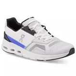 White athletic shoe with black and blue accents, featuring a distinctive sole design and ventilation patterns on the upper.