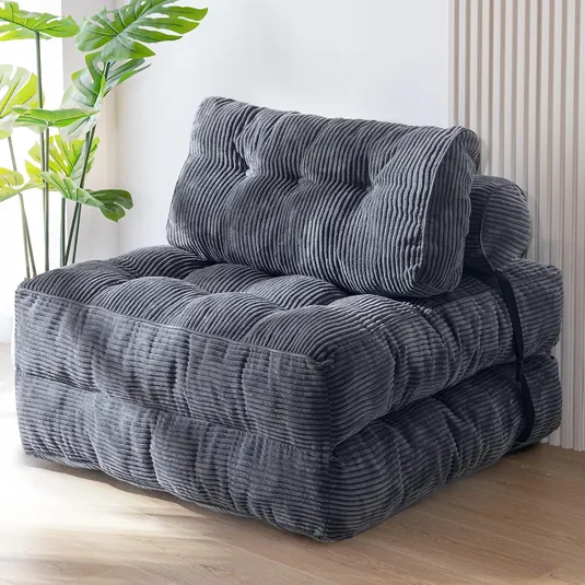 Gray foldable floor chair with a ribbed texture and plush cushioning, secured with a black strap.
