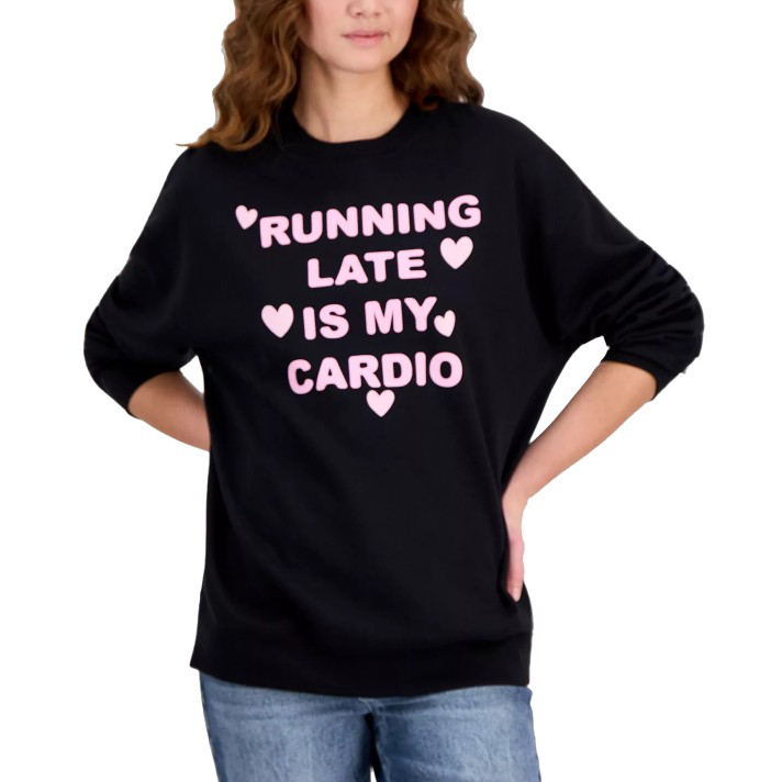 A black sweatshirt with pink text saying \“Running Late is My Cardio\“ includes decorative hearts. The person wearing it also has blue jeans on.