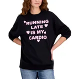 A black sweatshirt with pink text saying \“Running Late is My Cardio\“ includes decorative hearts. The person wearing it also has blue jeans on.