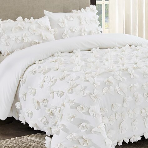 White queen comforter set with 3D floral texture, featuring soft, fabric flowers covering the surface. Includes matching pillow shams for a cohesive look.