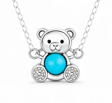 A teddy bear pendant necklace featuring a turquoise-colored body and sparkling accents on a silver chain.