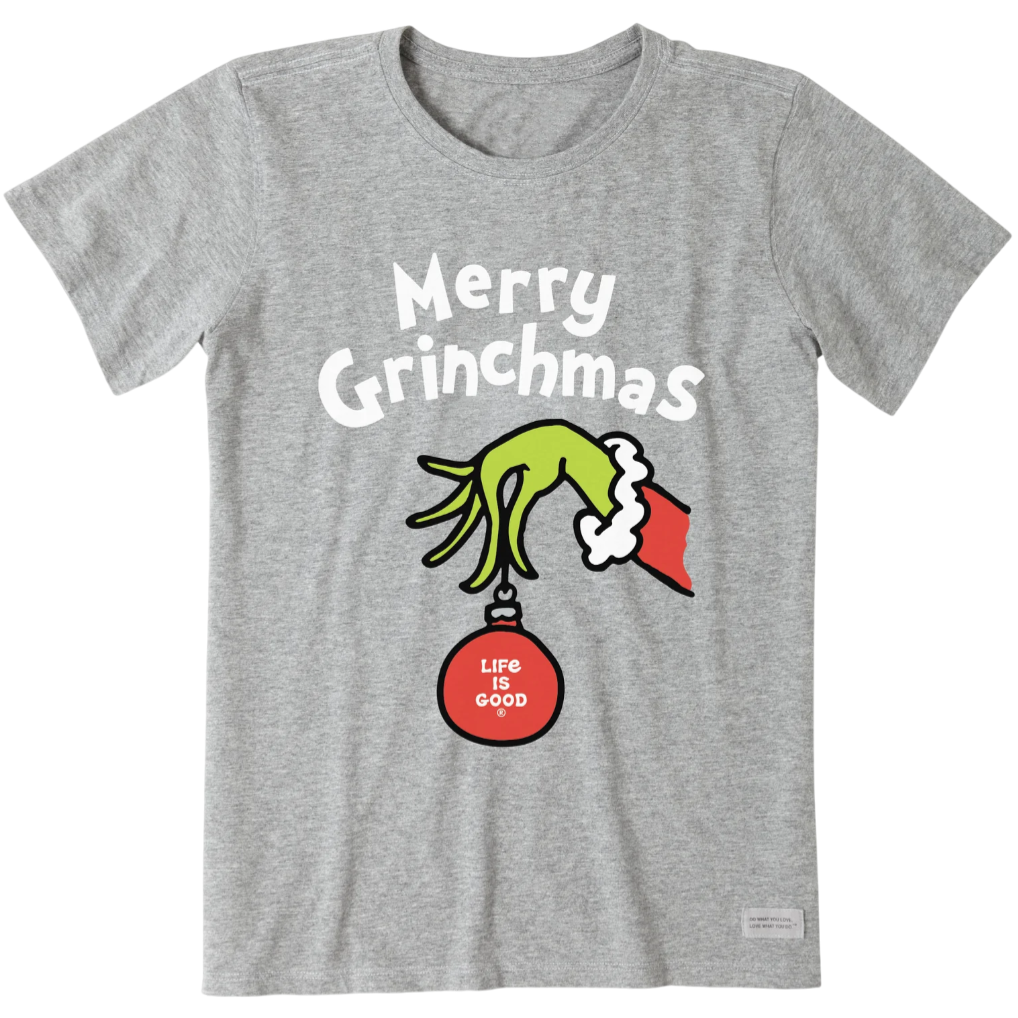Gray T-shirt featuring \“Merry Grinchmas\“ text, an illustration of a green hand holding a red ornament with \“Life is Good\“ on it.