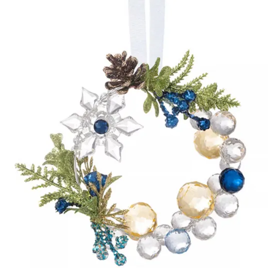 This is a decorative holiday wreath ornament featuring clear, blue, and gold faceted beads, adorned with green foliage, a pinecone, and a crystal-like snowflake design.