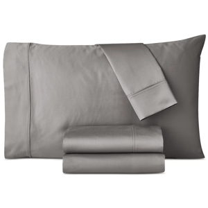 A set of gray bed linens, including a pillowcase, flat sheet, and fitted sheet, is neatly folded and displayed.