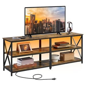 A rustic TV stand with open shelving, featuring a wood and metal design, holding a flat-screen TV, headphones, and other accessories. It includes integrated power outlets for convenient device charging.