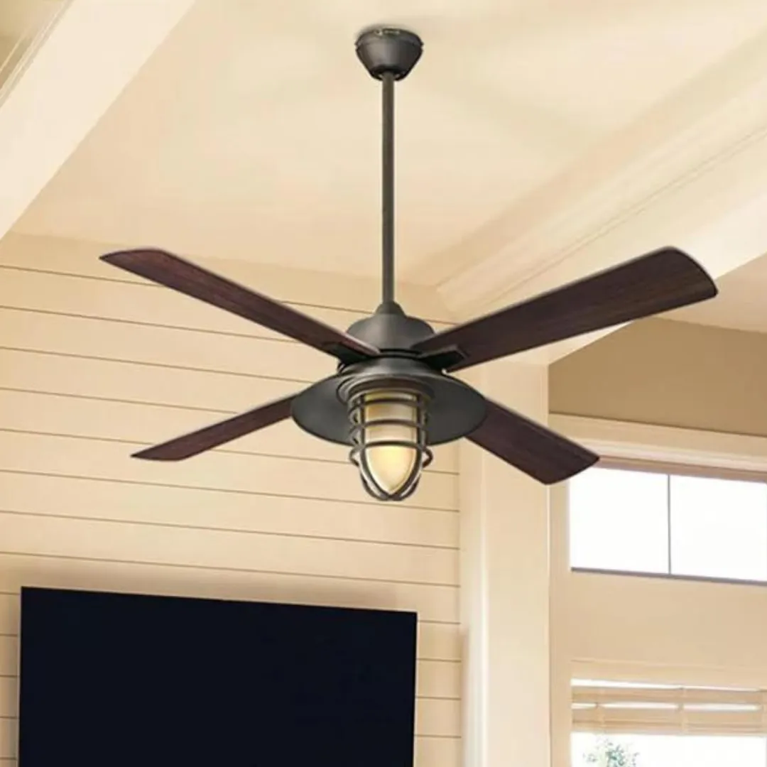Ceiling fan with dark wooden blades and a central light fixture is installed on a beige interior ceiling.