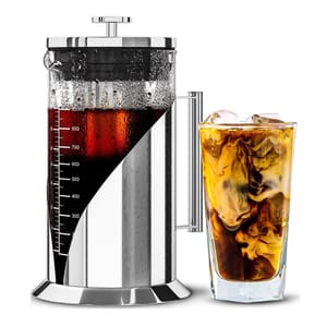 A stainless steel French press filled with coffee is shown alongside a glass of iced coffee with milk swirling inside.