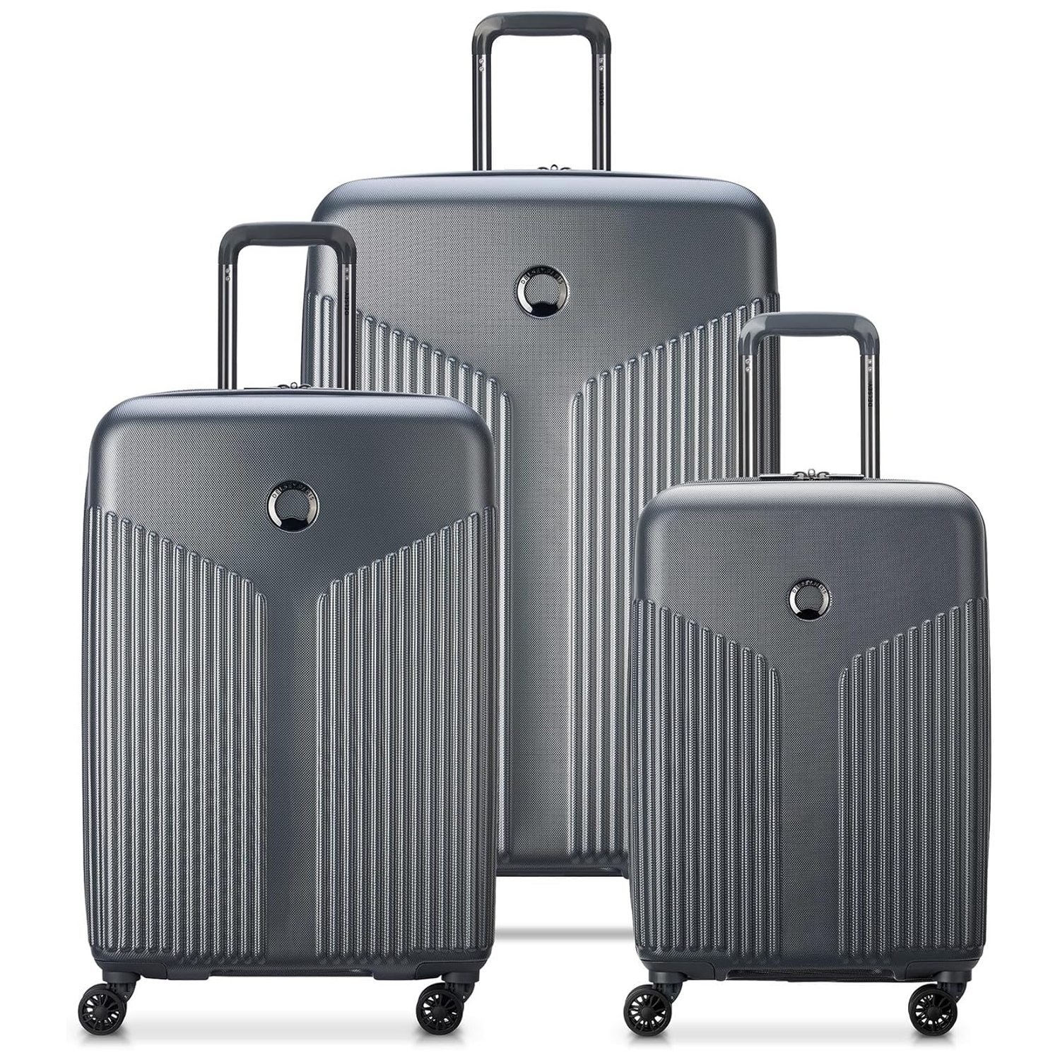 3-piece Delsey Paris hardside luggage set in metallic gray with a textured, ribbed design. Each suitcase features telescopic handles and four spinner wheels; available in small, medium, and large sizes for versatile packing needs.