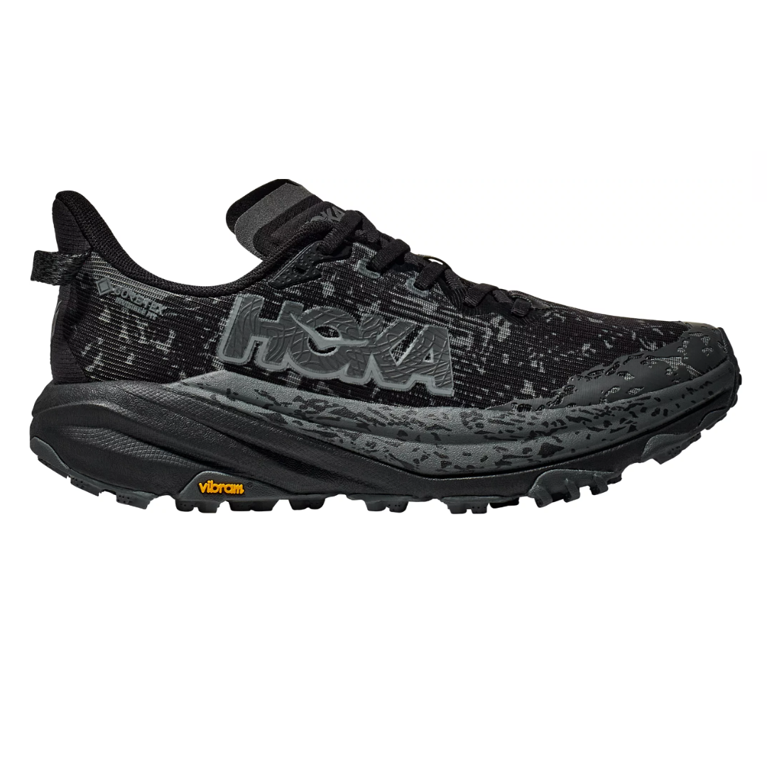 HOKA Women's Speedgoat Trail Shoes in black feature a rugged design with Gore-Tex for waterproofing and a durable Vibram sole for enhanced traction, suitable for trail running.