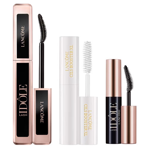 Three Lancôme mascara products: Idôle Lash, Cils Booster XL primer in white, and a compact travel-size Idôle Lash mascara, featuring curved brushes and sleek packaging.