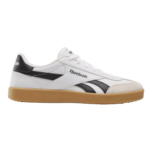 A white Reebok sneaker with black accents and a gum sole, featuring classic branding on the side and heel.