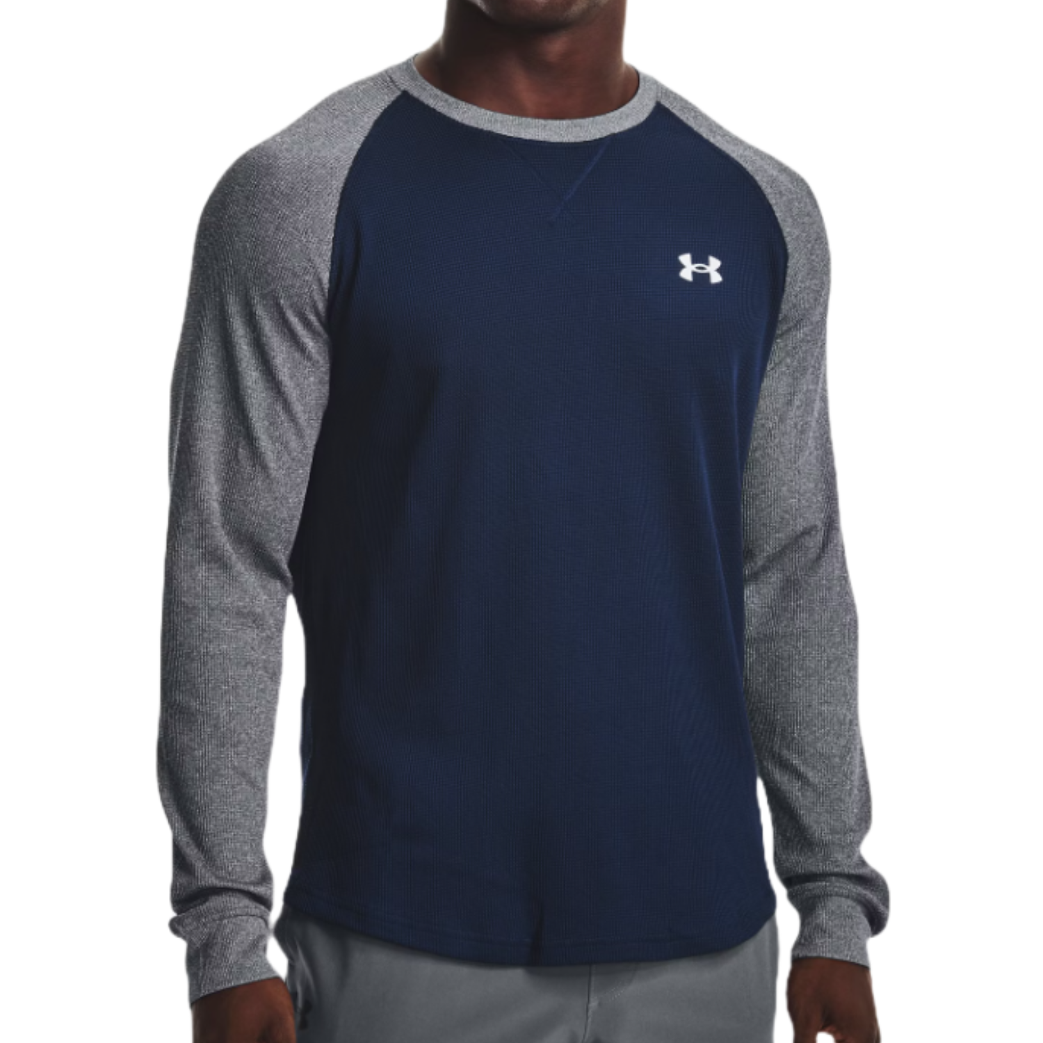 The Under Armour Waffle Crew is a long-sleeve shirt with a navy front and gray heather sleeves, featuring a small Under Armour logo on the chest. It combines a waffle-knit texture for warmth and comfort.