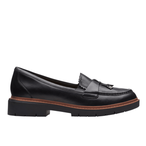 Black leather loafer with a tassel detail, featuring a chunky rubber sole and a brown trim accent.