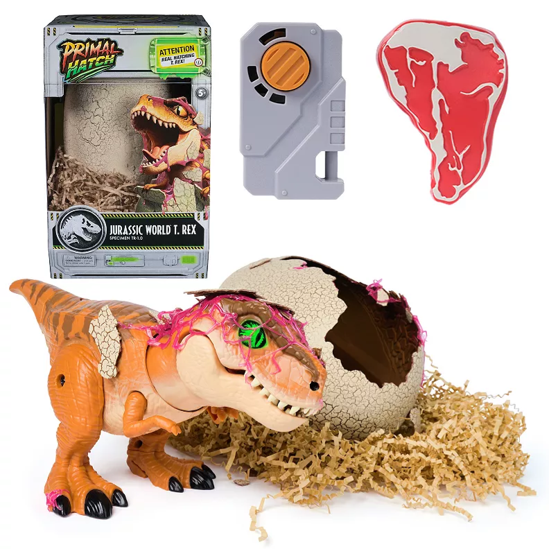 Jurassic World T. Rex toy with a hatching egg, remote control, and cardboard packaging featuring the Primal Hatch design.