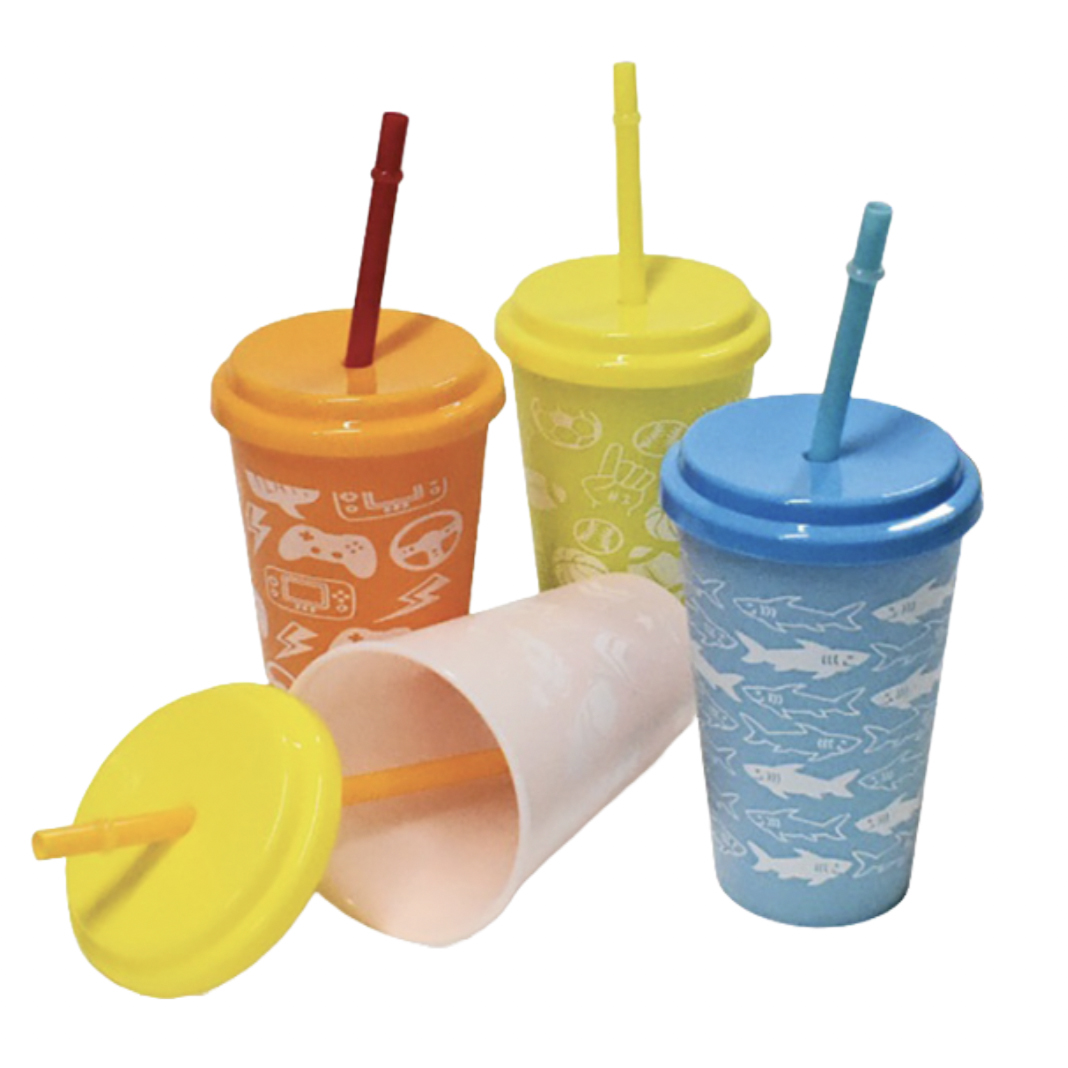 A 3-pack of color-changing tumblers features yellow, orange, and blue cups with matching lids and straws. Each tumbler has distinctive patterns like sharks, controllers, and playful graphics.