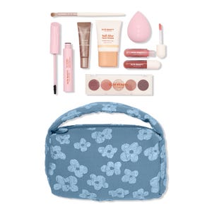 Makeup set featuring a brush, mascara, inner glow eye primer, soft blur face primer, makeup sponge, two lip products, eyeshadow palette, and a floral-patterned blue bag.