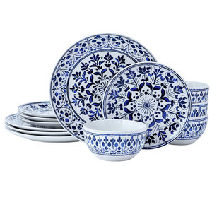 A set of blue and white dinnerware featuring plates and bowls with intricate floral patterns.