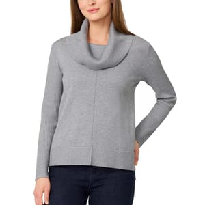 A woman is wearing a gray cowl neck sweater with ribbed cuffs and hem, paired with dark jeans.