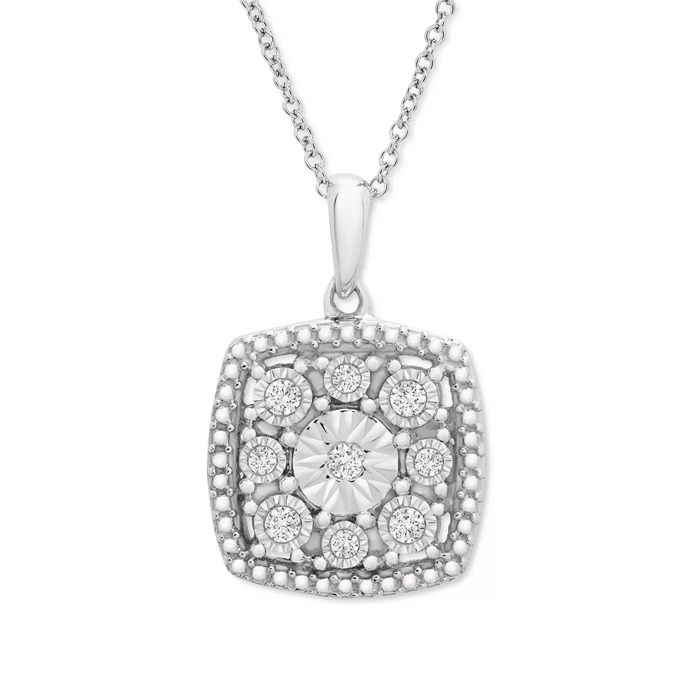 A sterling silver necklace features a cushion-shaped pendant embellished with multiple small diamonds encircling a larger central diamond, and intricate beaded detailing on a delicate silver chain.