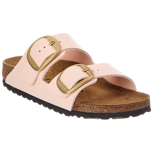 A pink sandal with two adjustable gold buckles, a cork footbed, and a black rubber sole.