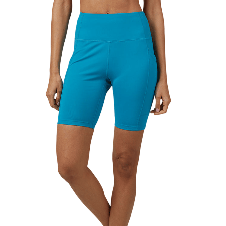Turquoise high-waisted athletic shorts paired with white sneakers, featuring a form-fitting design and knee-length cut.