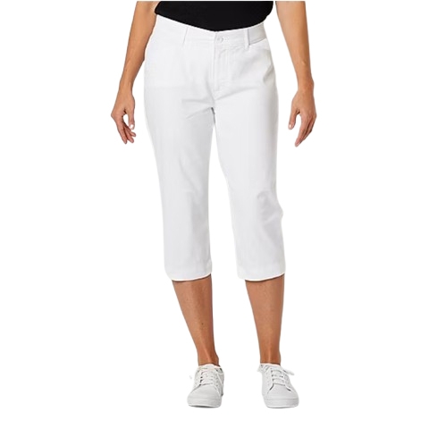 White mid-rise capri pants with a fitted silhouette, reaching just below the knee, featuring a button and zip closure, and paired with white sneakers.