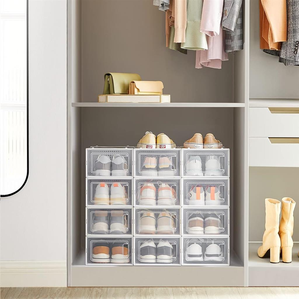 Transparent shoe storage boxes are neatly organized in a closet alongside hanging clothes and boots.