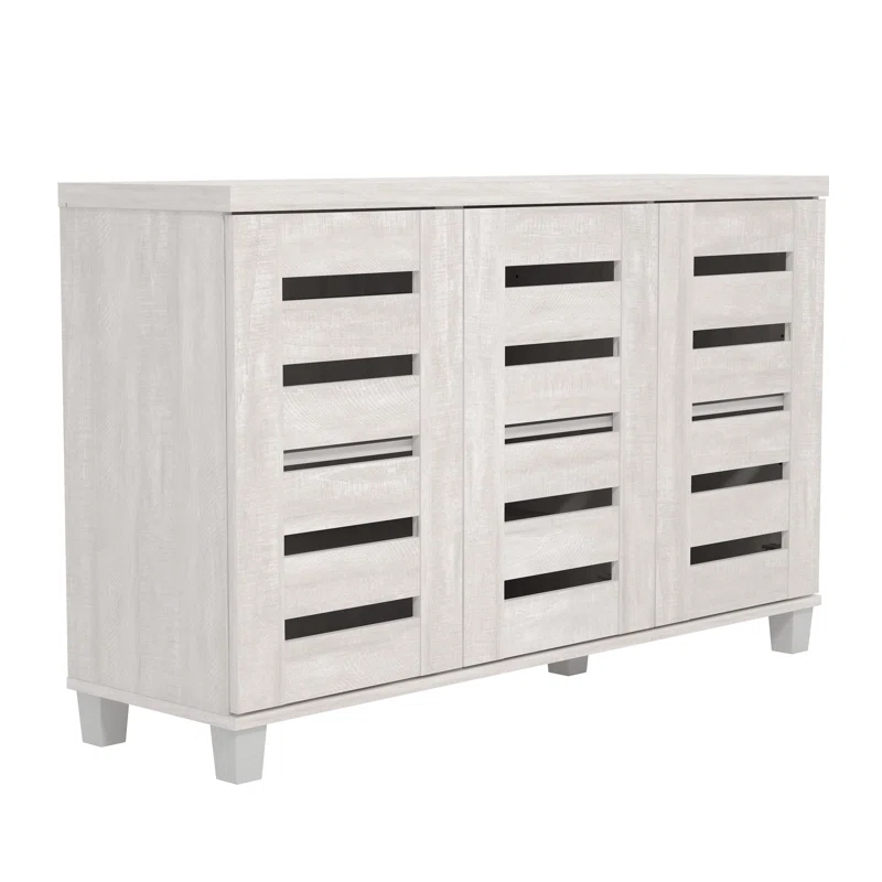 A white, three-door cabinet with a slatted design, featuring a clean and minimalist appearance, stands on four short legs.