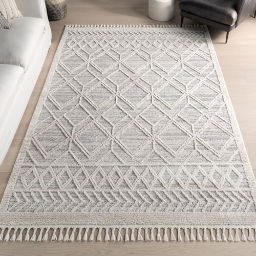 A rectangular rug with a gray and white geometric lattice pattern and tassels along the shorter edges.